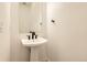 Stylish powder room with pedestal sink and modern black faucet at 11442 Autumn Moon St, Littleton, CO 80125