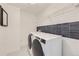 Bright laundry room with washer, dryer, and stylish tile at 2362 W 167Th Ln, Broomfield, CO 80023