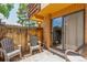 Backyard patio with gray chairs and sliding glass door access at 6465 Welch St, Arvada, CO 80004