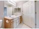 Bathroom features double sinks, light wood cabinets, and a bathtub at 1120 Opal St # 104, Broomfield, CO 80020