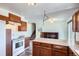 Kitchen with wood cabinets, white appliances, and an island at 9552 Field Ct, Broomfield, CO 80021