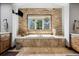 Relaxing bathroom with soaking tub, stone accents, and double vanities at 4923 Raintree Cir, Parker, CO 80134