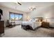 Spacious main bedroom with a king-size bed and a sitting area at 4923 Raintree Cir, Parker, CO 80134