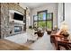 Spacious living room with stone fireplace and large windows at 4923 Raintree Cir, Parker, CO 80134