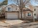 Two-story house with attached garage and a well-maintained front yard at 1191 Conifer Ct, Highlands Ranch, CO 80126