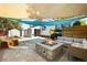 Backyard patio with fire pit, seating area, and shade sail at 7307 S Birch St, Centennial, CO 80122