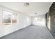 Bright sunroom with windows and gray carpeting at 7307 S Birch St, Centennial, CO 80122