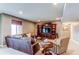 Finished basement with leather furniture and built-in shelving at 12044 Fontberry St, Parker, CO 80134