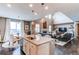 Open floor plan boasts a kitchen island, Gathering room with fireplace, and hardwood floors at 12044 Fontberry St, Parker, CO 80134