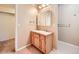 Good-sized bathroom with wood vanity and a separate shower at 2256 S Dexter St, Denver, CO 80222