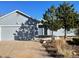 House exterior featuring a two-car garage and landscaping at 4482 S Argonne Ct, Aurora, CO 80015