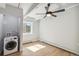 Bright bedroom with new flooring, a ceiling fan, and laundry area at 590 N Logan St # 210, Denver, CO 80203