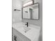 Modern bathroom with white vanity, black matte fixtures, and a large mirror at 590 N Logan St # 210, Denver, CO 80203