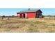 Red barn with two stalls and a horse visible at 10691 County Road 23, Fort Lupton, CO 80621