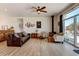 Cozy living room featuring a wood-burning stove, comfortable seating, and sliding glass doors leading to the patio at 10691 County Road 23, Fort Lupton, CO 80621