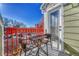 Balcony with table and chairs, offering views of the parking lot and trees at 970 S Dawson Way # 10, Aurora, CO 80012