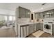 Modern kitchen with gray cabinets, stainless steel appliances, and a view into the living room at 970 S Dawson Way # 10, Aurora, CO 80012