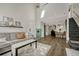 Open living area with vaulted ceilings, gray sectional sofa, and a cozy fireplace at 970 S Dawson Way # 10, Aurora, CO 80012