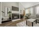 Living room featuring a gas fireplace, hardwood floors, and ample natural light at 970 S Dawson Way # 10, Aurora, CO 80012