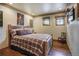 Charming bedroom with rustic wood bed frame and plaid bedding at 327 Peerless Dr, Breckenridge, CO 80424