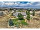 Aerial view of a house with a spacious backyard and surrounding landscape at 4974 Malibu Dr, Berthoud, CO 80513