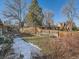 Large backyard with wooden fence and landscaping at 5931 E 6Th E, Denver, CO 80220