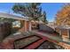 Landscaped backyard with a raised garden bed and modern fence at 5702 E 14Th Ave, Denver, CO 80220