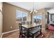 Dining room with sliding door access to backyard, hardwood floors and a wood table at 12202 Village W Cir, Commerce City, CO 80603