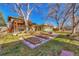 Spacious backyard with a pergola, raised garden beds, and mature trees at 12240 E Florida Ave, Aurora, CO 80012