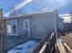View of backyard, wooden deck, and partial fence with snow at 1103 Stage Dr, Fort Lupton, CO 80621