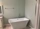 Modern bathroom with soaking tub, updated fixtures, and tile flooring at 1103 Stage Dr, Fort Lupton, CO 80621