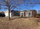 Ranch style home with gray siding, attached garage, and a spacious yard at 1103 Stage Dr, Fort Lupton, CO 80621