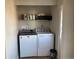 Bright laundry room, complete with washer, dryer, and shelving for storage at 1103 Stage Dr, Fort Lupton, CO 80621