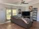 Living room featuring a sofa, TV, and ample natural light at 1103 Stage Dr, Fort Lupton, CO 80621
