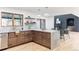 Modern kitchen with island and marble countertops at 1 Winged Foot Way, Littleton, CO 80123