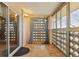 Enclosed balcony with tiled floor, decorative curtains, and sliding glass door at 585 S Alton Way # 4D, Denver, CO 80247