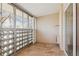 Enclosed balcony with tiled floor, sliding glass doors, and exterior brick wall at 585 S Alton Way # 4D, Denver, CO 80247