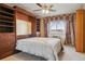Bedroom with built-in headboard, shelving, drawers, and window with curtains at 585 S Alton Way # 4D, Denver, CO 80247