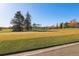 View of the golf course with putting green, netting, and trees at 585 S Alton Way # 4D, Denver, CO 80247