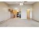 Open-concept living area with adjacent kitchen and ceiling fan at 585 S Alton Way # 4D, Denver, CO 80247