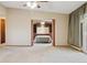 Living room with carpeted flooring, ceiling fan, and open doorway to the bedroom at 585 S Alton Way # 4D, Denver, CO 80247