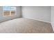 Bright and airy bedroom with neutral carpet and large window at 2204 Alyssa St, Fort Lupton, CO 80621