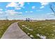 Concrete pathway winds through a grassy community park at 2204 Alyssa St, Fort Lupton, CO 80621