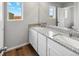 Double vanity bathroom with granite countertop at 2204 Alyssa St, Fort Lupton, CO 80621