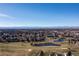 Wide aerial view of community, golf course and mountains at 1993 S Xanadu Way, Aurora, CO 80014