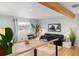 Mid-century modern living room with hardwood floors and stylish furniture at 5183 W Columbia Pl, Denver, CO 80236