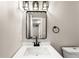 Modern bathroom with white sink, black fixtures and rectangular mirror at 5535 W Indore Dr, Littleton, CO 80128