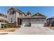 Two-story home with a two-car garage and landscaped front yard at 8742 Larch Trl, Parker, CO 80134