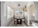 Bright dining area features a round table and ample natural light at 7121 W 52Nd Ave, Arvada, CO 80002