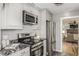 Modern kitchen with stainless steel appliances and granite countertops at 7121 W 52Nd Ave, Arvada, CO 80002